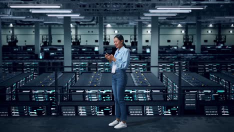 woman using smartphone in a data center