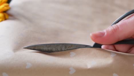 Flower-arrangement-scissors-cutting-wrapping-paper-close-up-in-slow-motion-4K