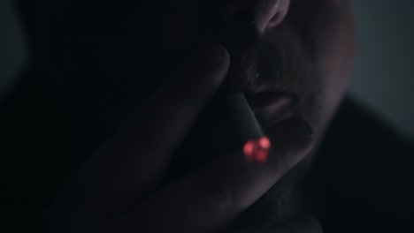 close-up of a man smoking a cigarette