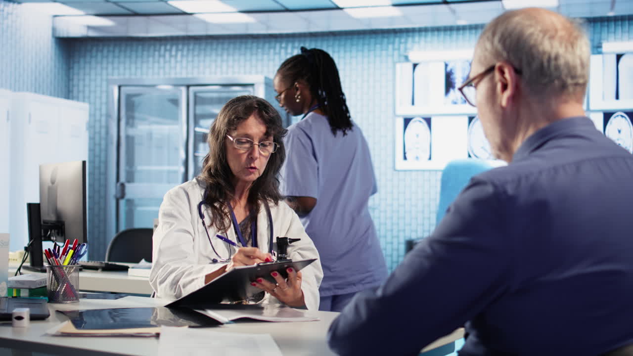 Vertical Video Skilled medical expert analyzing x ray scans for old patient on insurance