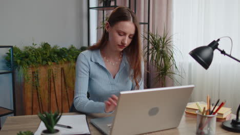 Young-business-woman-works-on-laptop-makes-online-purchases,-study,-e-learning,-remote-job-at-office
