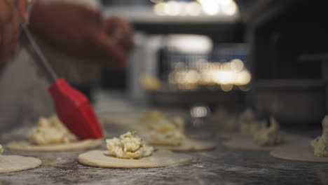 closeup footage of cooks preparing panzerotti at italian restaurant