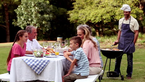 happy family eating in a park