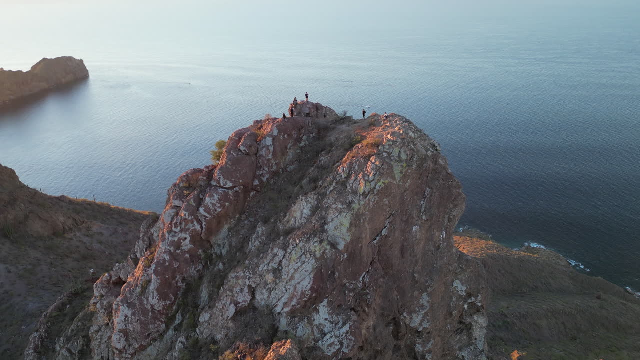 aerial shot of a mountain peak with people at the top 2