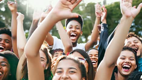 a group of young people with their hands in the air