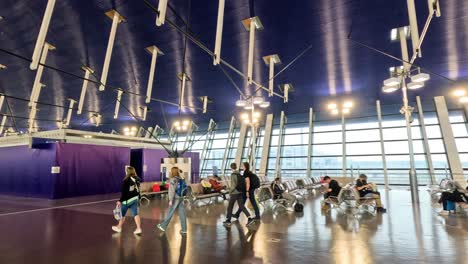 passengers walking through a modern airport terminal