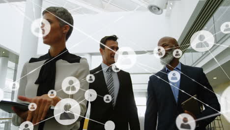 animation of network connections over business professionals walking in modern office