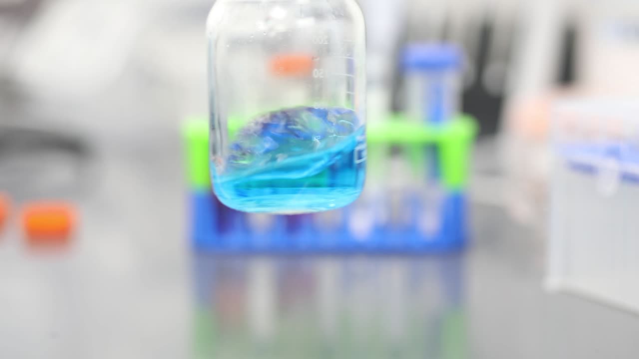 Blue Liquid swirling in a beaker in a laboratory