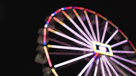 defocused ferris wheel in at night in a amusement park