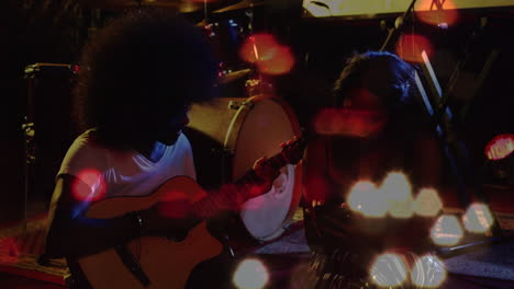 male guitarist and vocalist jamming in music studio, showing animated sound bars and drum kit icon