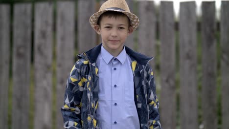 happy boy in hat shows his hand class