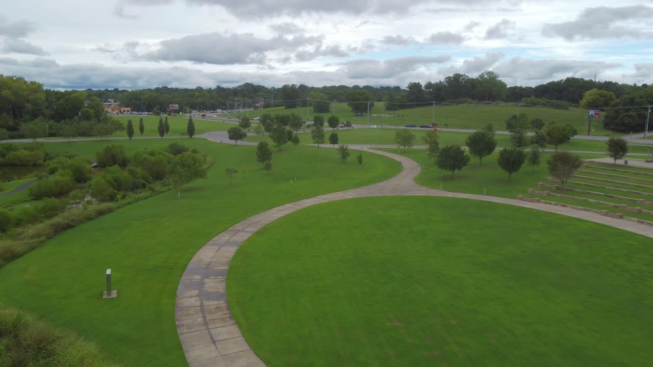 Drone flying forward, revealing an enormous park and green environment belonging to Wilma Rudolph Event Center in Clarksville, Tennessee neighborhood, USA
