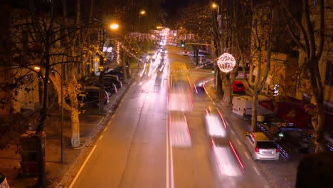 night traffic timelapse in the italian town of jesi - traditional buildings with passing vehicles and pedestrians