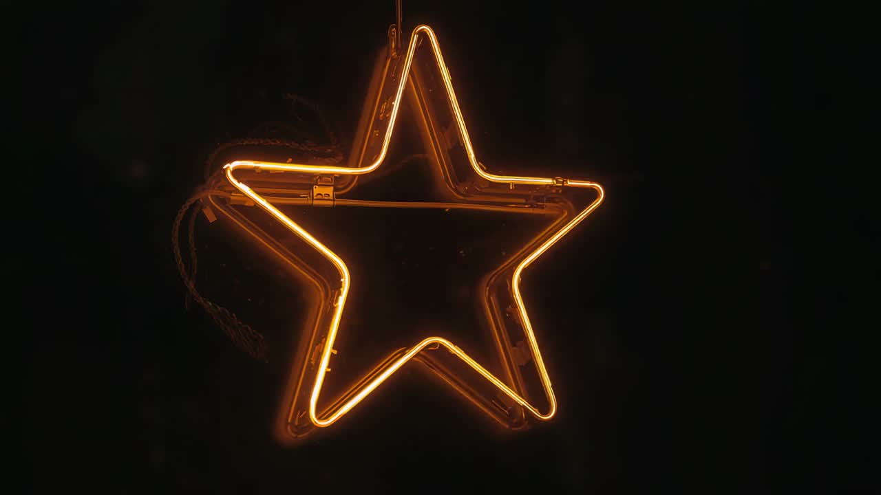 Flickering neon star tube reacting to power fluctuation while glowing against dark wall, with wires