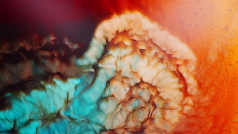 fusion of different hues of ink getting mixed forming shimmering galaxy