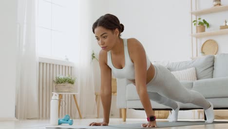 woman doing push-ups at home