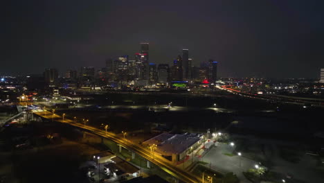 Drone-approaching-the-Houston-Skyline-from-the-North-side,-foggy-night-in-USA