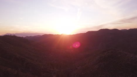 Amazing-sunset-over-Delamar-Mountain,-Big-Bear-Lake-California,-aerial-pull-away