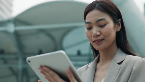 businesswoman using tablet outdoors