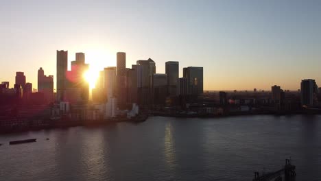 aerial - sunset over river thames and canary wharf, london, scenic pan right