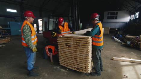 A-group-of-workers-moves-wood-slats-in-stock-5