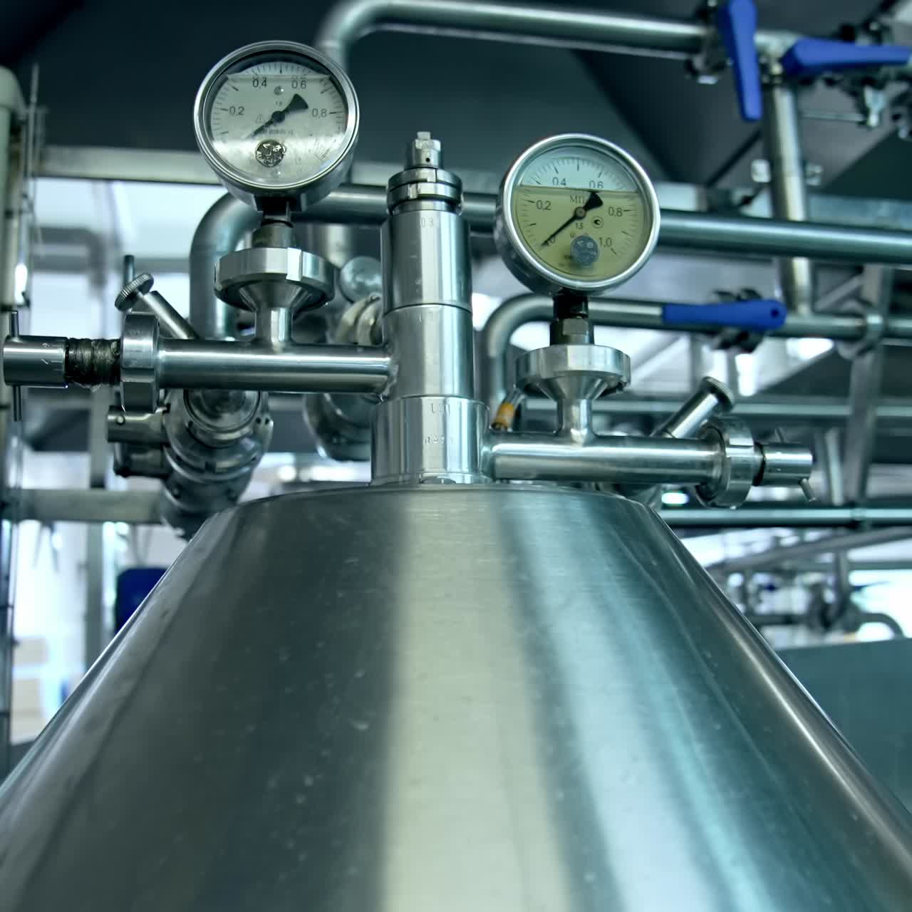 Steel shiny tubes with sensors and valves interlinking with each other. Complicated equipment for dairy food production