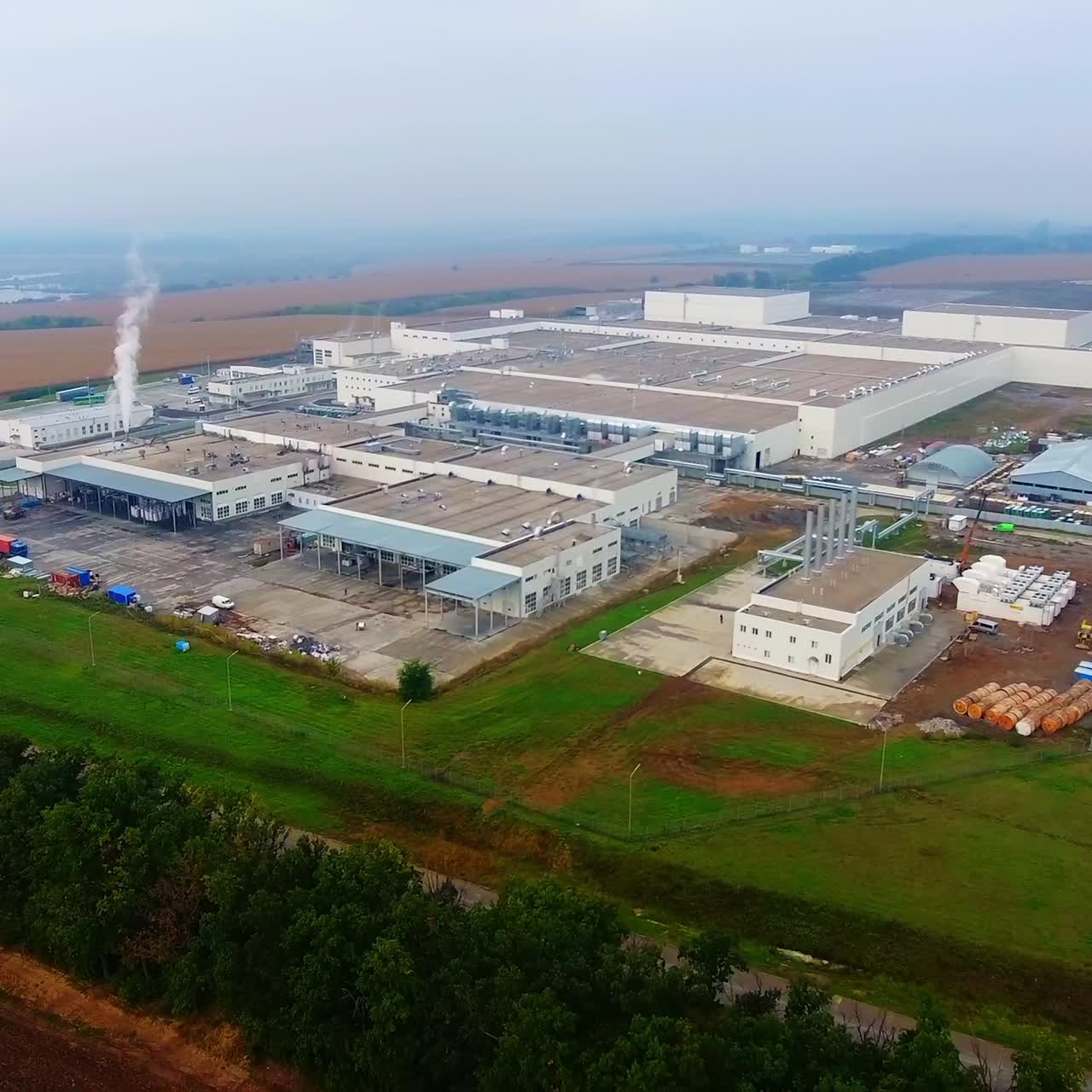 Modern industrial building exterior with aerial view. Gray industrial building from above