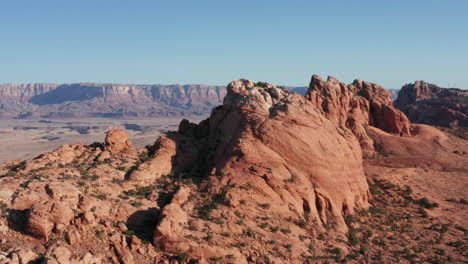 Drone-pulls-backward-from-rock-formation-and-shows-valley-and-canyon