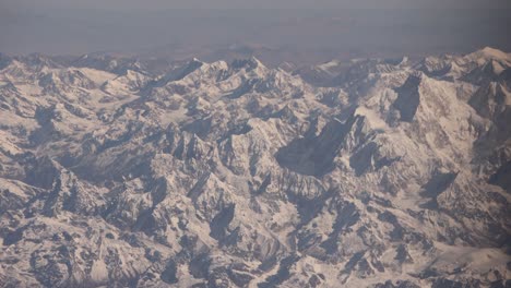 Scenic-aerial-flight-over-the-worlds-largest-mountains,-the-Himalayas-with-views-of-Mount-Everest-and-jagged-snowcapped-peaks