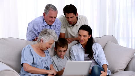 familia extendida usando portátil juntos