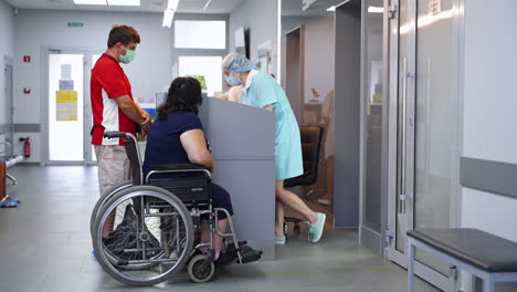 hospital reception with patient in wheelchair