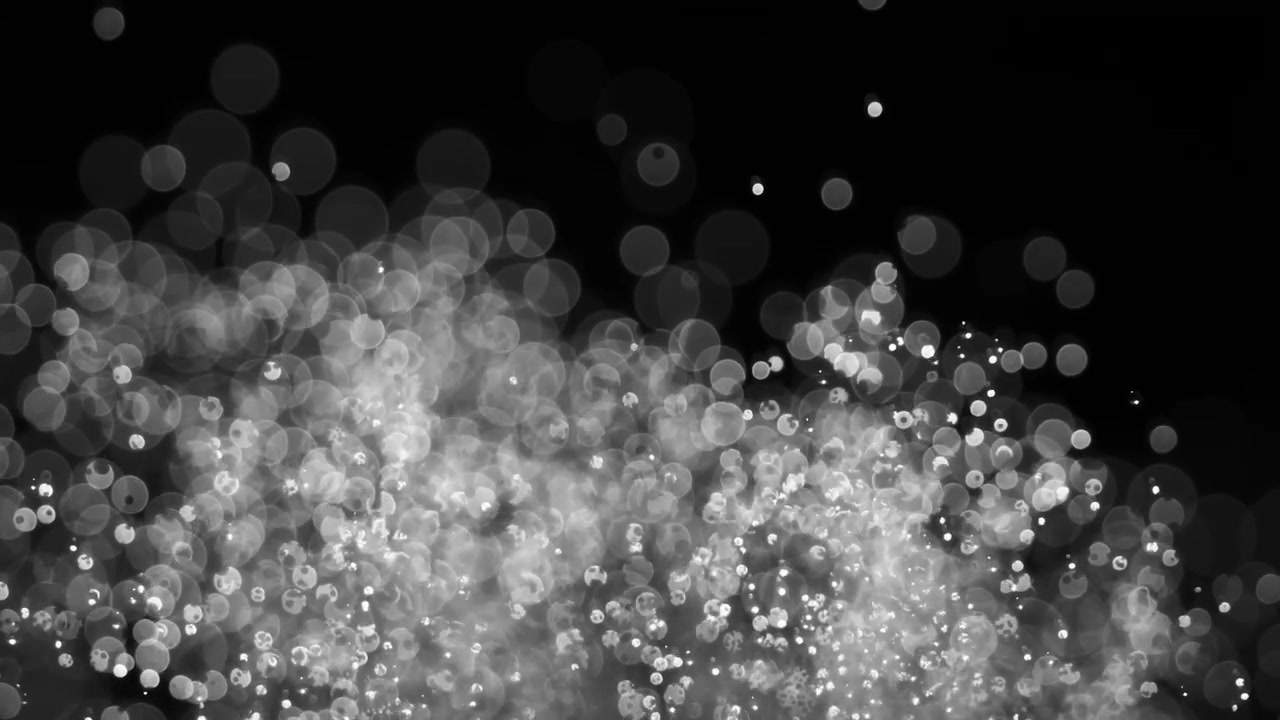 Particelle astratte bokeh fluttuanti su sfondo scuro. Ripreso con una fotocamera super slow motion a 1000 fps
