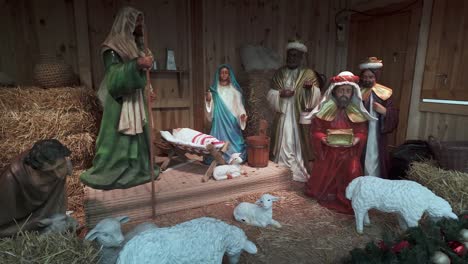 christmas nativity scene: manger with sheep, wise men, baby jesus