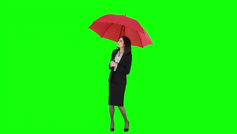 businesswoman standing under umbrella