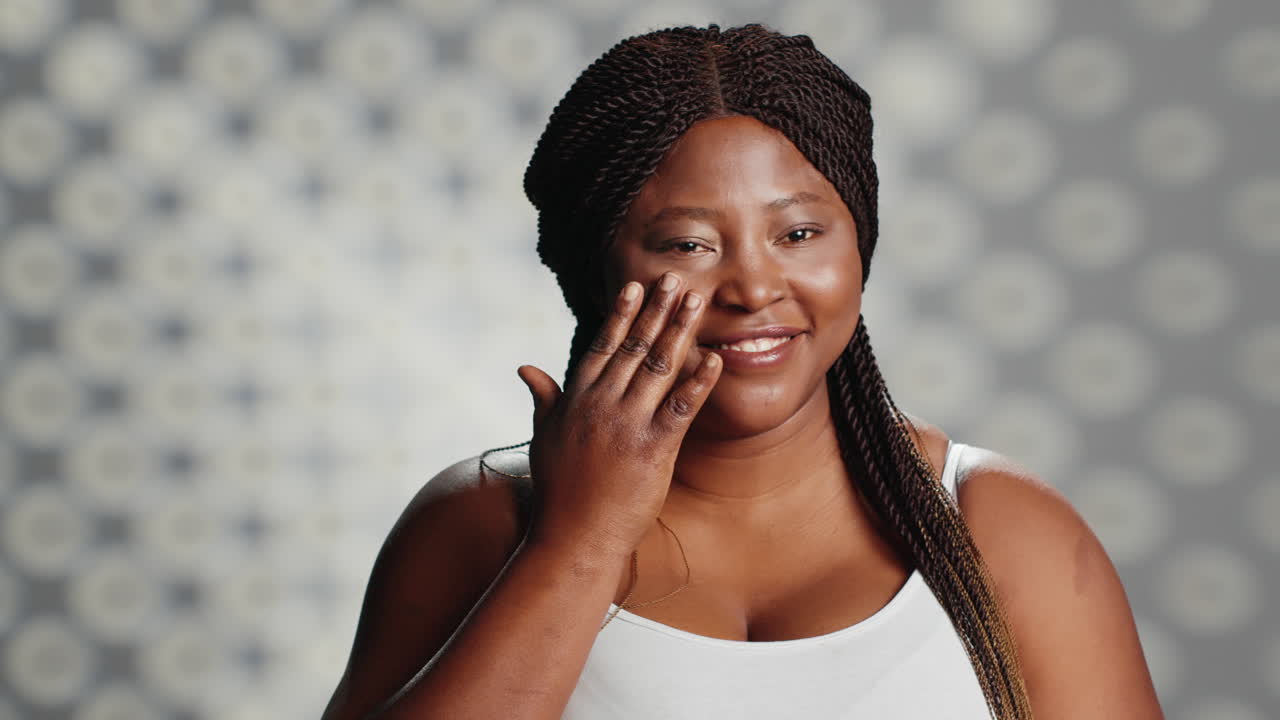 African American Woman Applying Skincare