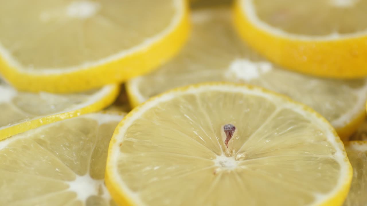 Sliced juicy lemon rotates slowly.