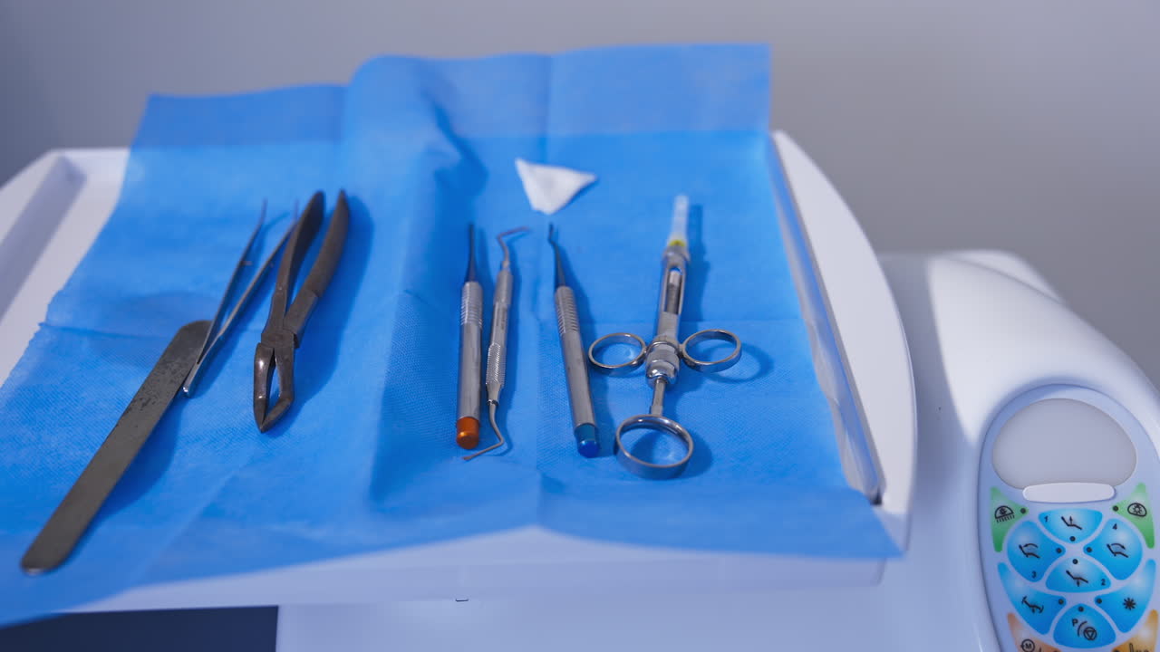 Metal tools for dentistry laid on napkin. Some rather old instruments for removal of teeth that can't be treated. Close up.