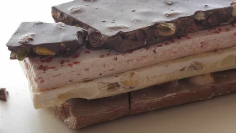 delicious white and dark chocolates with nutty decorations, perfect for advertisements, food blogs, or any sweet-themed media