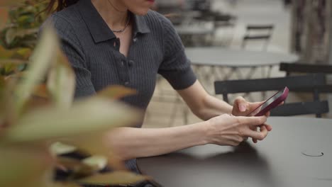 woman using smartphone in a cafe