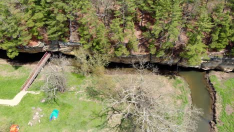 River-running-along-a-rock-face-wall-at-a-county-park