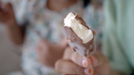 child eating a chocolate ice cream