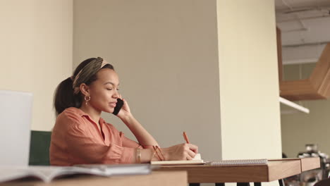 businesswoman making phone call in cafe