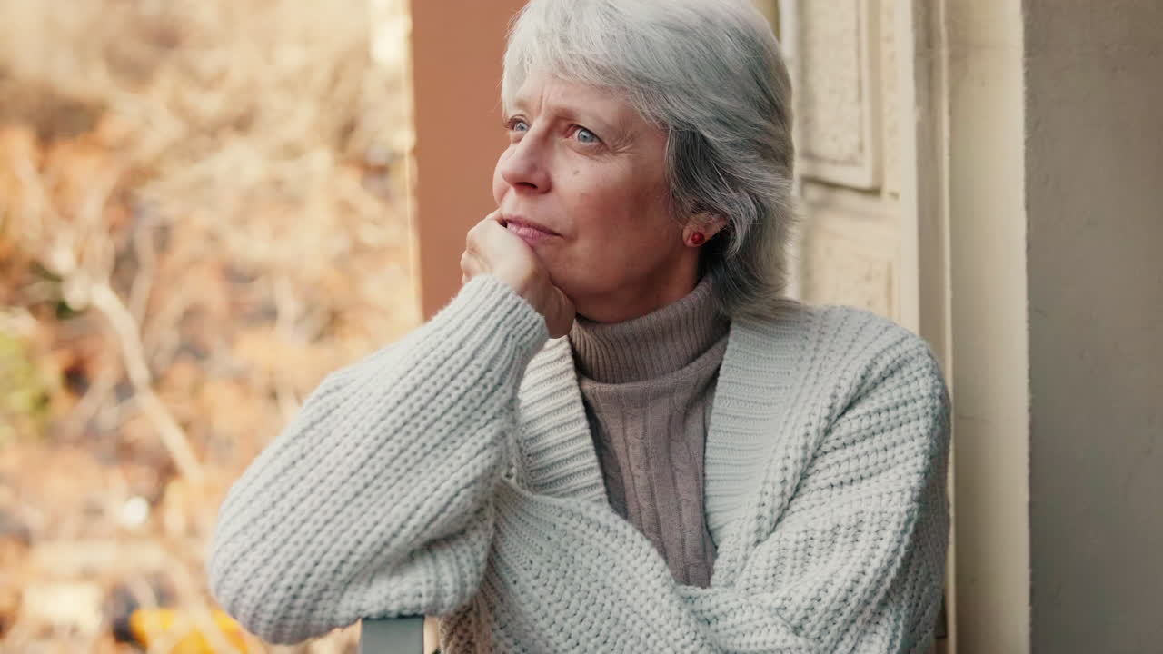 Contemplative Older Woman on Balcony