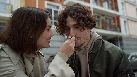 Lovely-couple-kissing-outdoor.-Man-licking-lips-in-front-of-woman-on-street.