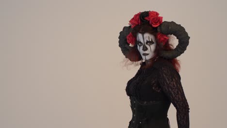 woman in a dark fantasy costume with horns and roses