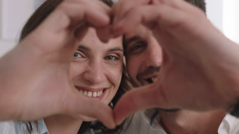 happy couple making heart shape with hands gesturing romantic commitment enjoying loving relationship on valentines day