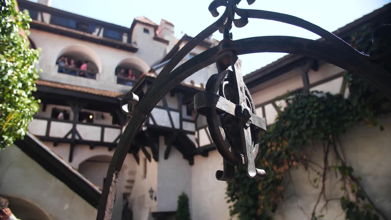 Exterior architectural detail of metal wheel over well at Dracula Castle, showing historic design and medieval stonework