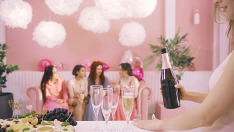 Side-View-Of-Woman-Pouring-Champagne-In-Crystal-Glasses-On-The-Table