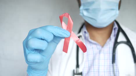 doctor holding a red ribbon