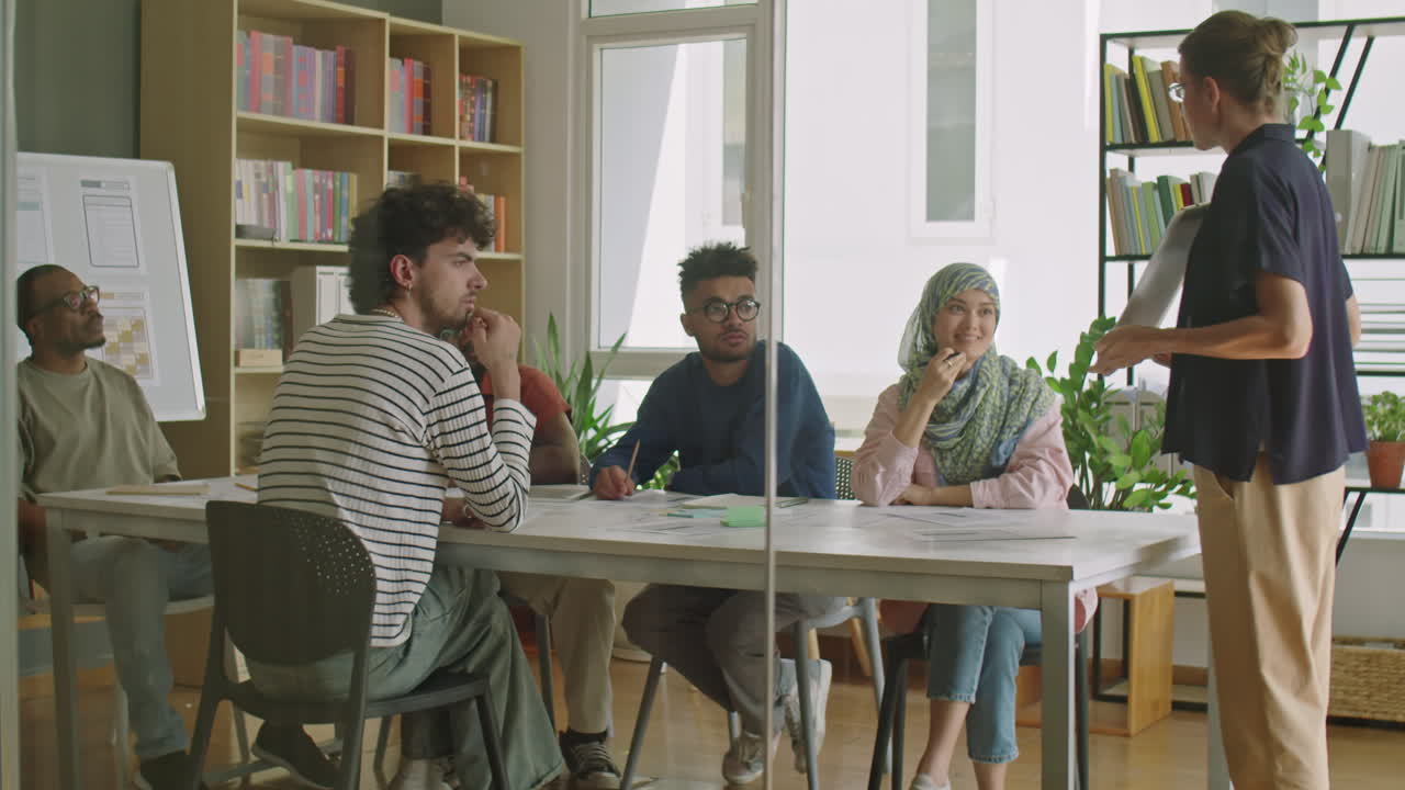 Female Teacher Giving Lesson to Immigrants in Language School